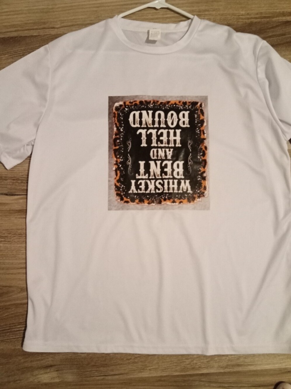 White Graphic Tee with Black and Orange Plaque Print. Upside Down Quote!